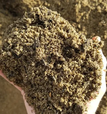 Bio Retention Blend with coarse, sandy texture held in hand.